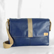 A messenger bag with Southwest Airlines leather in blue and tan colors with an adjustable cotton strap, handcrafted in the Hudson Valley.