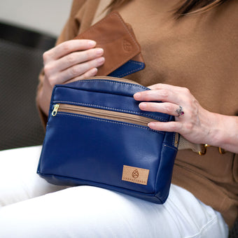 A person holding a southwest errand sitting own putting a southwest wallet in the errand 