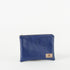 A royal blue zip pouch handcrafted from Southwest Airlines upcycled leather, with gold-tone hardware and a brand tag displaying Unshattered