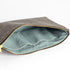 Gray large zippered pouch with light blue interior and gold zipper on a white background