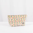 A multicolor confetti puff plush makeup kit with a gray label and gold tone hardware 