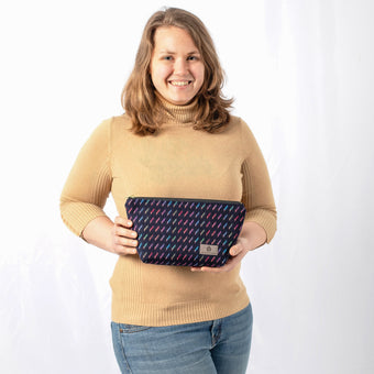 A woman holding this colorful makeup kit named after Stephanie 