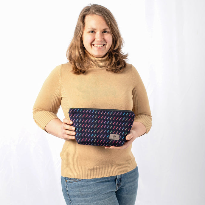 A woman holding this colorful makeup kit named after Stephanie 