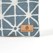 Suede Unshattered label on the Erica Zip Pouch handcrafted from upcycled blue geometric fabric