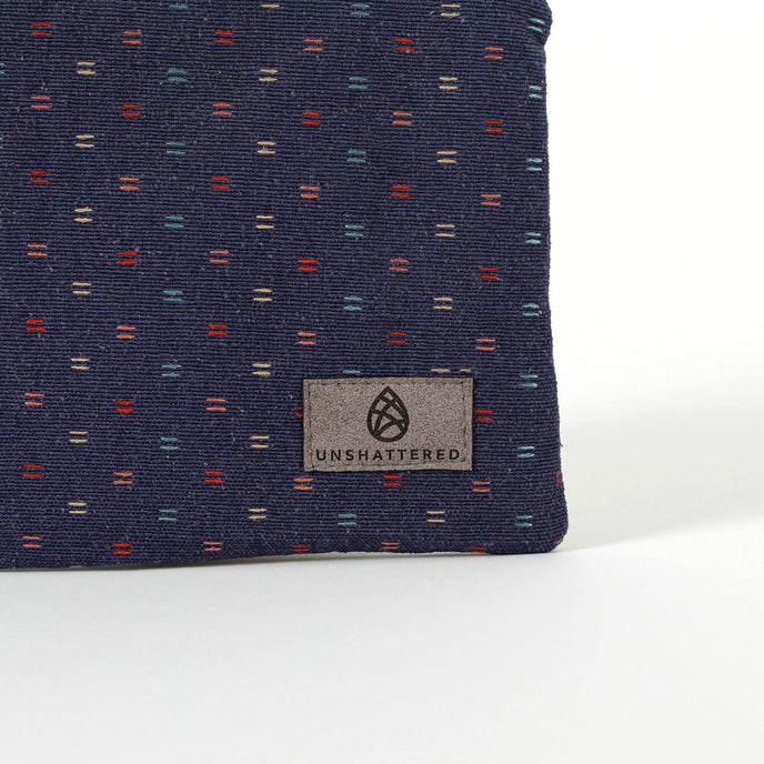 Gray suede Unshattered label on an upcycled blue fabric zip pouch named Nancy