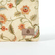 Suede label on a zip pouch made from upcycled floral fabric