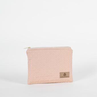 A pink and yellow zip pouch named after Susan featuring a tan Unshattered label 