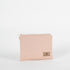 A pink and yellow zip pouch named after Susan featuring a tan Unshattered label 