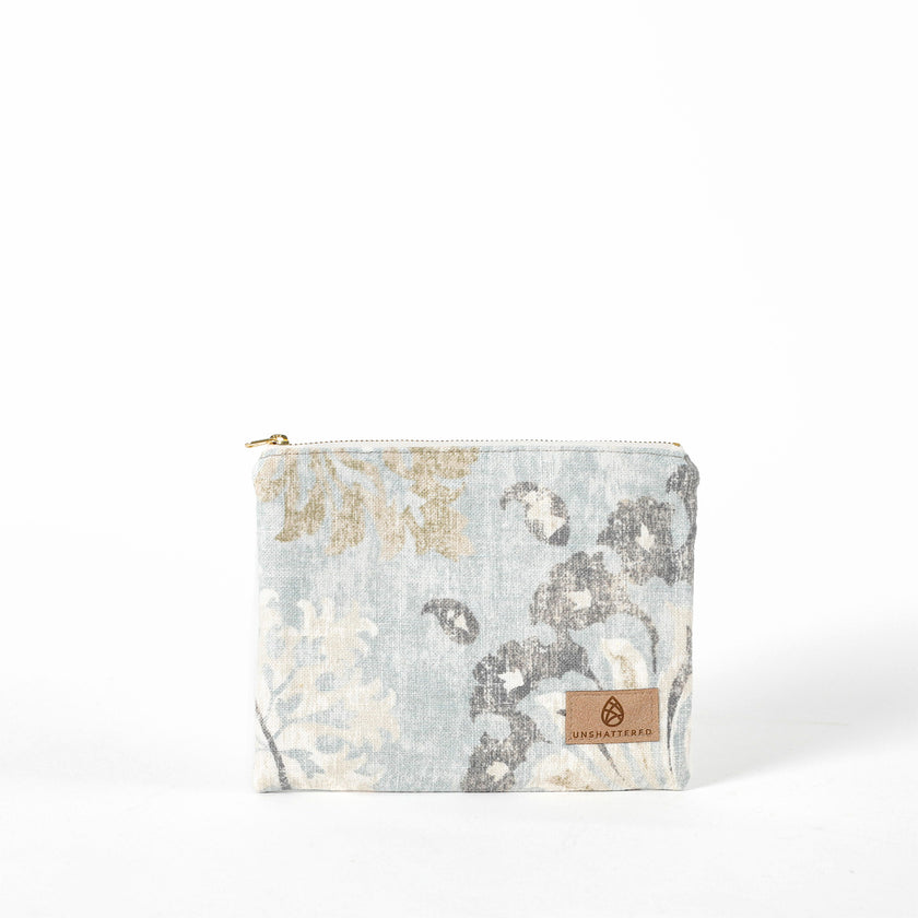 Floral patterned pouch with a brand logo on a white background named after Suzanne 