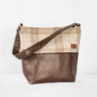 This brown Tamika tote bag and plaid fabric handbag on a white background