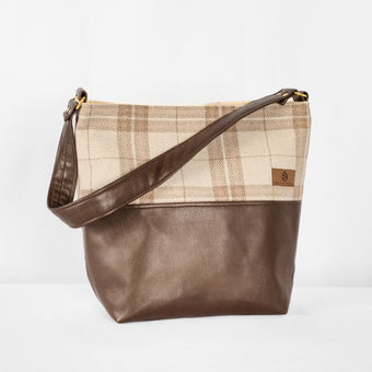 This brown Tamika tote bag and plaid fabric handbag on a white background