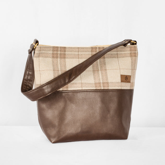 This brown Tamika tote bag and plaid fabric handbag on a white background