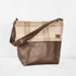 This brown Tamika tote bag and plaid fabric handbag on a white background
