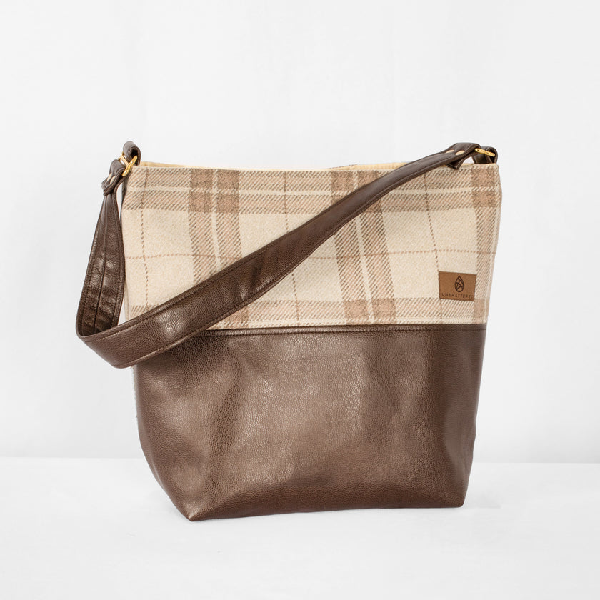 This brown Tamika tote bag and plaid fabric handbag on a white background