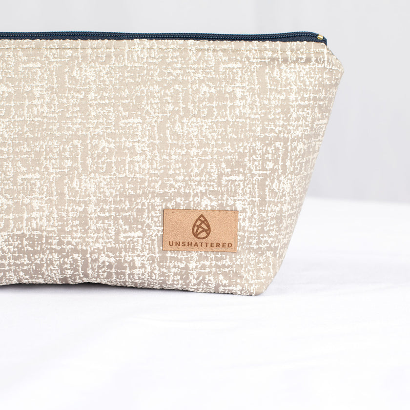 A tan label on a neutral makeup bag