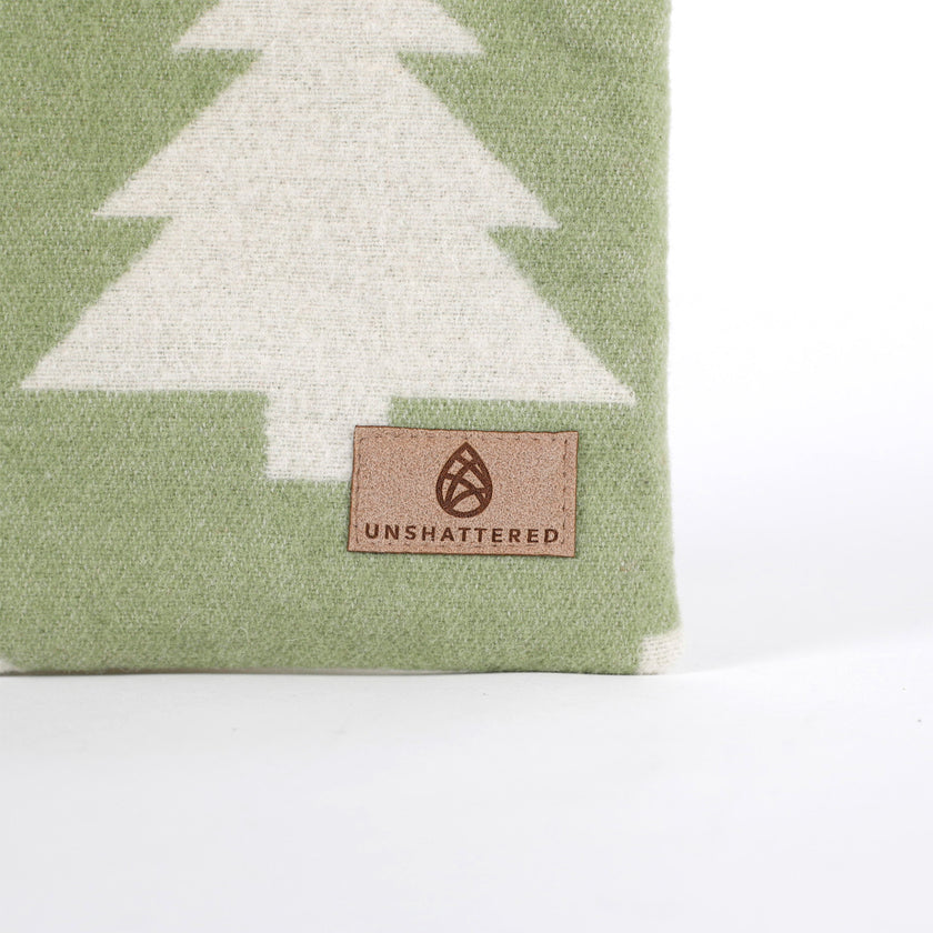 Green zip pouch named in honor of Vincent handcrafted from upcycled green, woolen fabric with white tree pattern and 'Unshattered' suede label