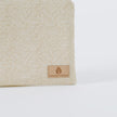 A tan label on a beige large zip pouch 