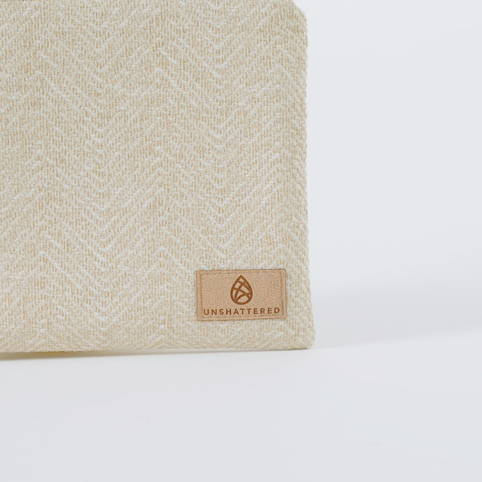 A tan label on a beige large zip pouch 