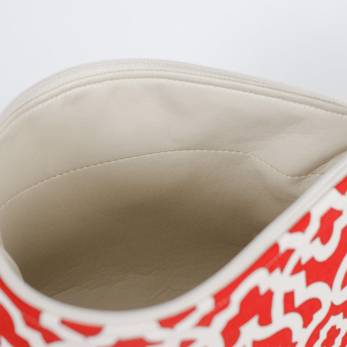 A taupe luxury leather alternative interior on a red and white design makeup bag 