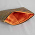 A orange fabric interior on this paisley large zip pouch with a gold tone zipper 