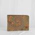 A large zip pouch with a paisley pattern in muted colors, featuring a brown zip closure and a small brown brand tag attached to the zipper.