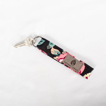 A loop keychain with a black-tone keyring and upcycled floral fabric attached to it, handcrafted in NY’s Hudson Valley named after Tiffanie.