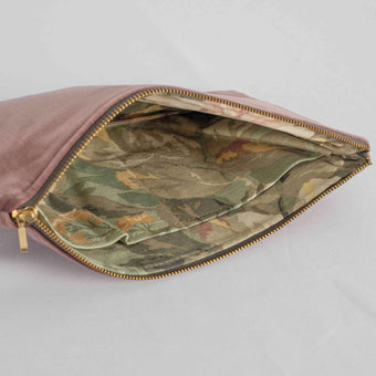 A floral pattern interior on this mauve velvet exterior and gold tone zipper 