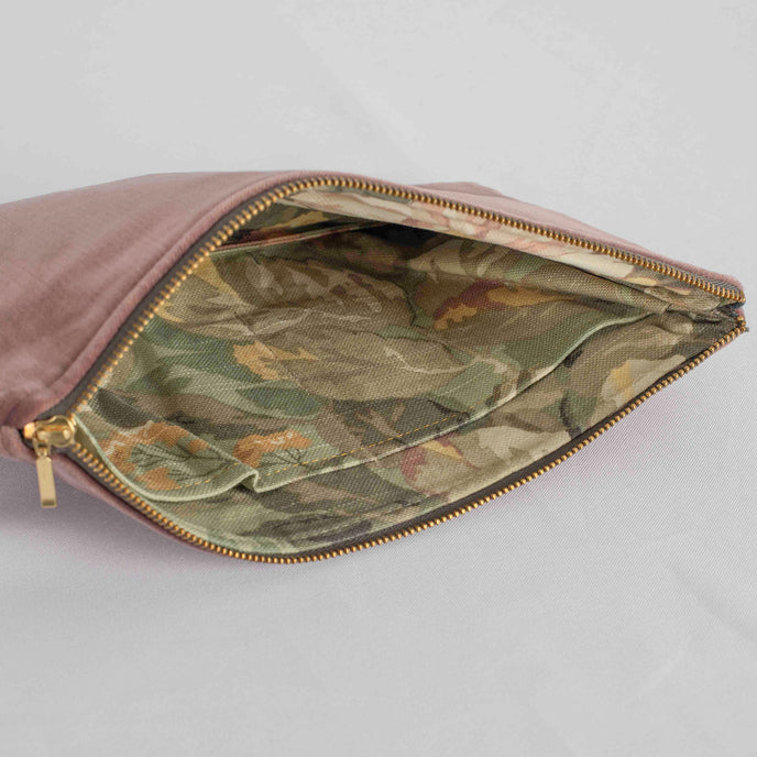 A floral pattern interior on this mauve velvet exterior and gold tone zipper 