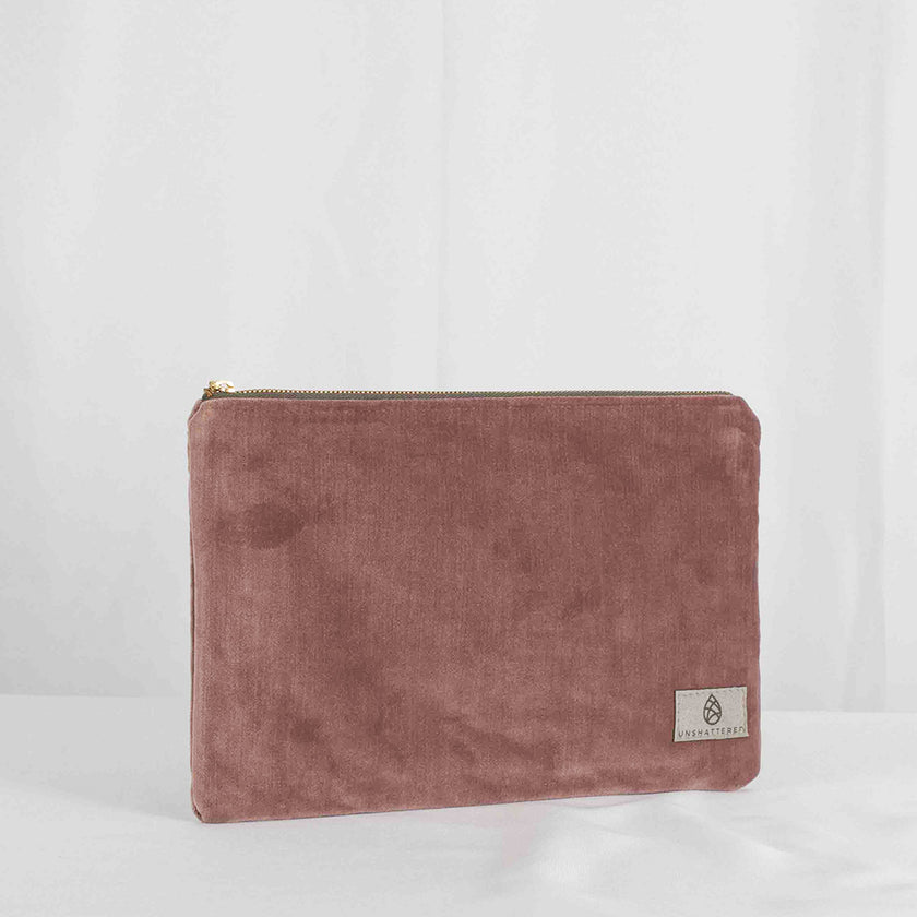 A large zip pouch with a mauve velvet exterior and a floral interior, featuring a zip closure and gold-tone hardware.