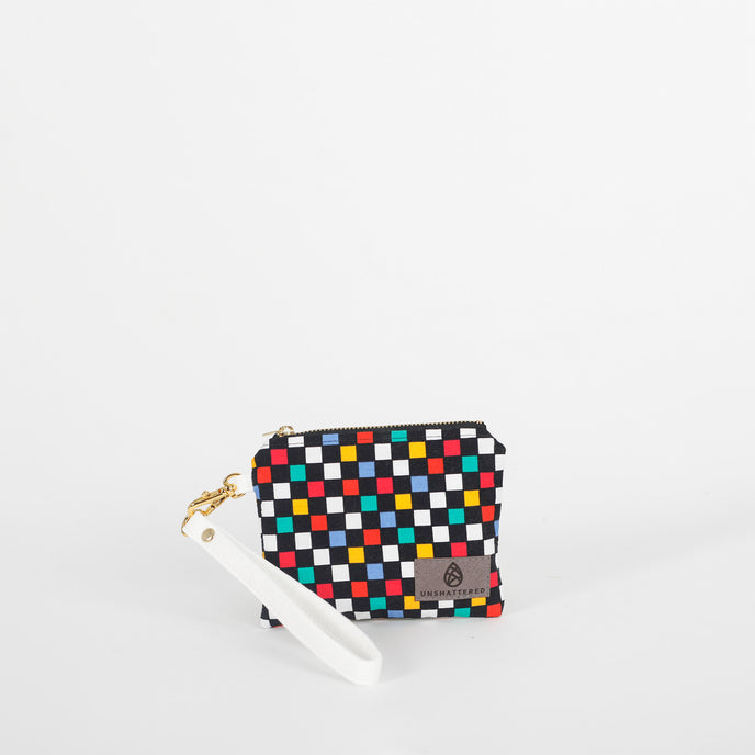 Small black, blue, red, yellow and white checkered zippered pouch with white leather alternative wristlet strap
