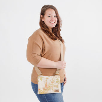 A woman carrying a Floral patterned crossbody bag named after Tyler 