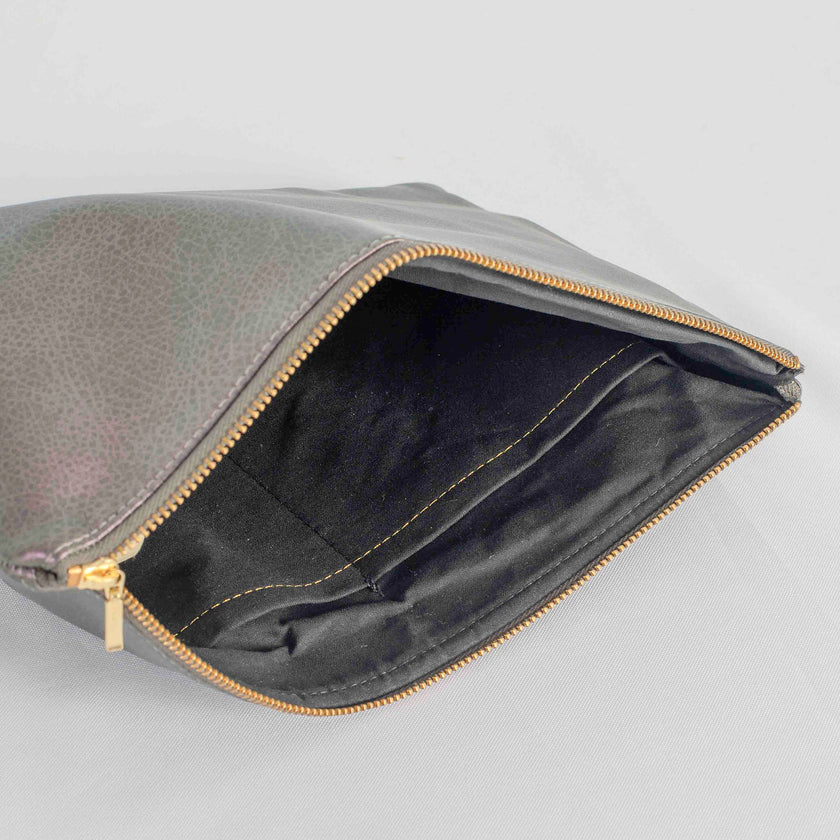 A black fabric interior on this purple luxury leather alternative exterior with a gold tone zipper