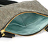Upcycled blue fabric interior on a textured gray crossbody pouch with a gold tone zipper 