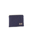 An upcycled blue fabric zip pouch named Nancy with a line rainbow pattern and gold-tone hardware on a white background