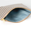 Open fabric pouch with upcycled checkered fabric exterior and solid blue interior on a white background