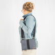 A woman wearing a west point dress gray crossbody pouch 