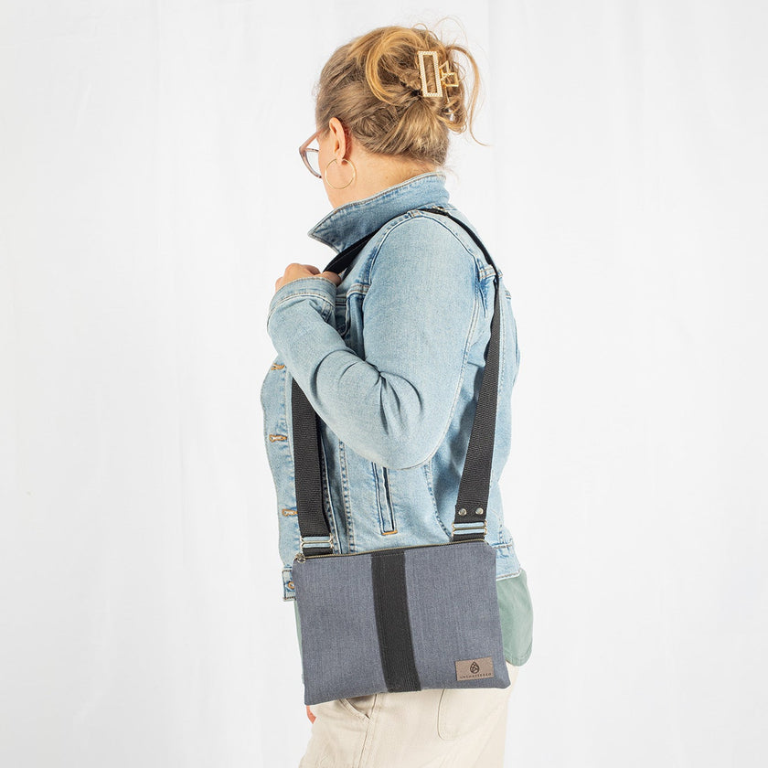 A woman wearing a west point dress gray crossbody pouch 
