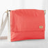A red and white large messenger bag made from formula e racing material with an adjustable strap, shown with a focus on the front pocket and the brand's tag 