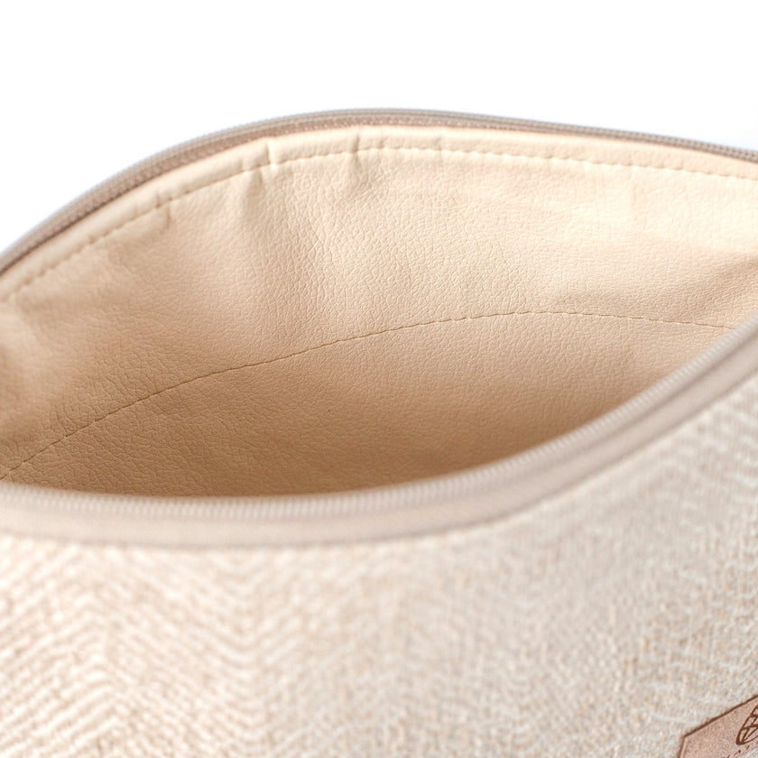 Close-up of a beige wipe-clean interior of a makeup bag made from upcycled beige material