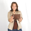 Woman holding a brown woven clutch against a white background