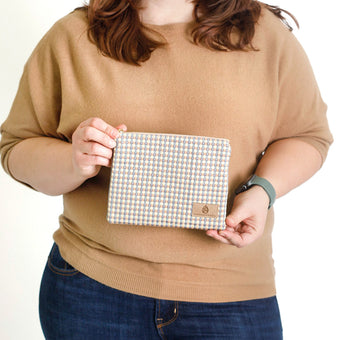 Woman holding a checkered pouch  named after Kara 