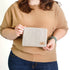 Woman holding a checkered pouch  named after Kara 