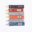Stylish and practical fabric wristlet key clip featuring a dotted pattern and elegant gold/silver-tone hardware.