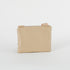 A cream wipe-clean back of a crossbody pouch with tan straps on a white background named after Lydia