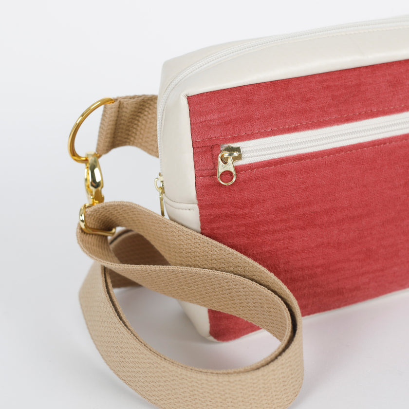 Red and beige errand bag with gold zipper pulls on a white background named after Tiara