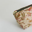 Floral-patterned pouch with a zipper on a white background named after Anitha 