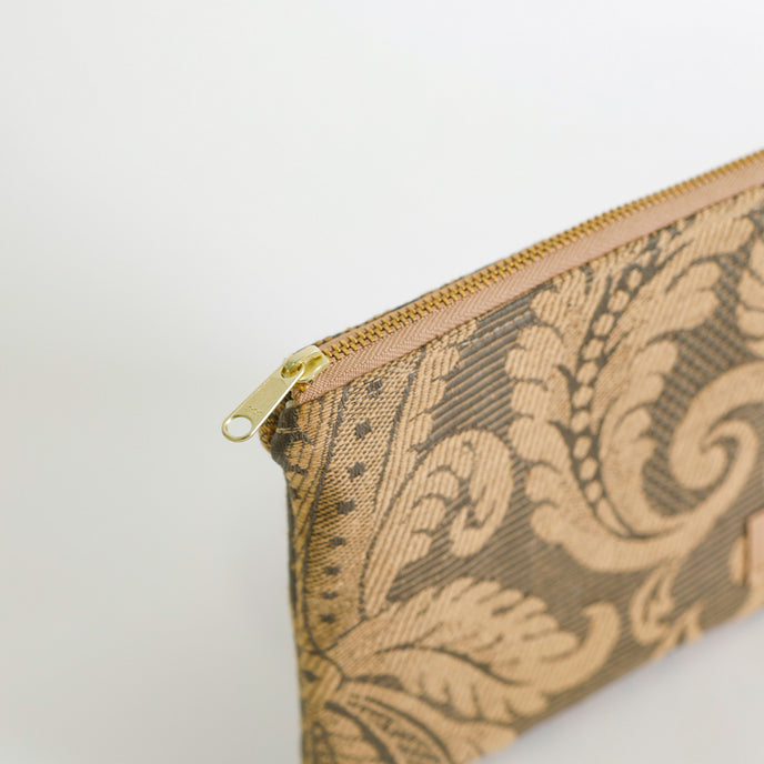 Patterned pouch with a gold zipper on a light background named after Salina