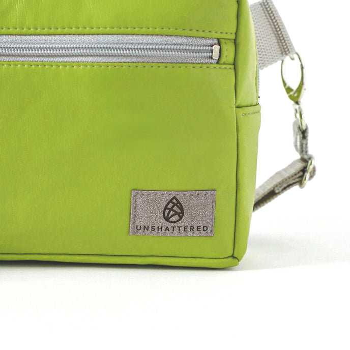 A lime green errand bag with an Unshattered gray label bag named after Nadine 