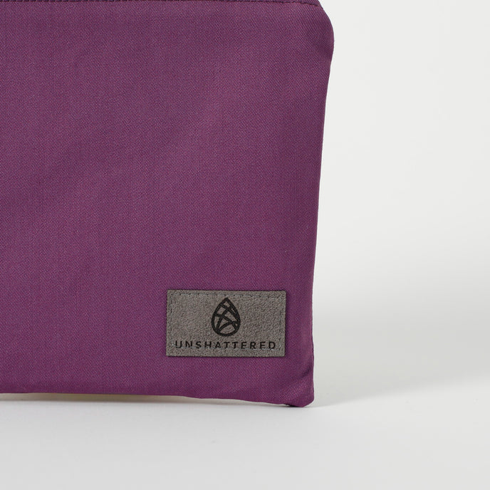 A gray label on a purple zip pouch named after Connie 