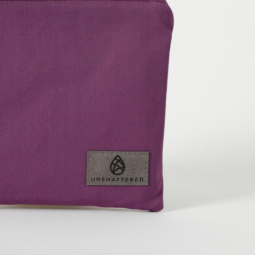 A gray label on a purple zip pouch named after Connie 